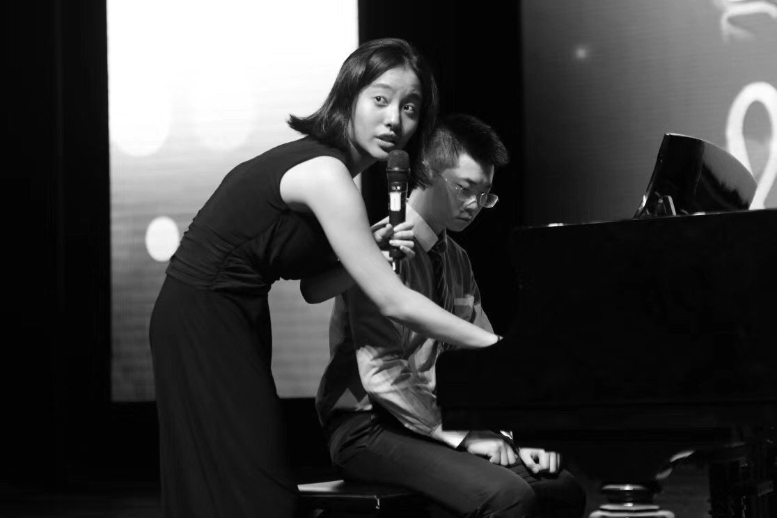 XinRu teaching a student on stage